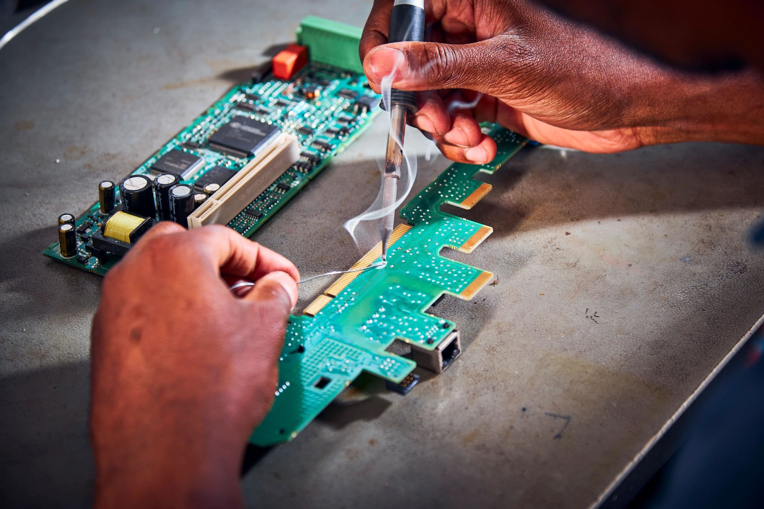 Technician soldering a printed circuit board